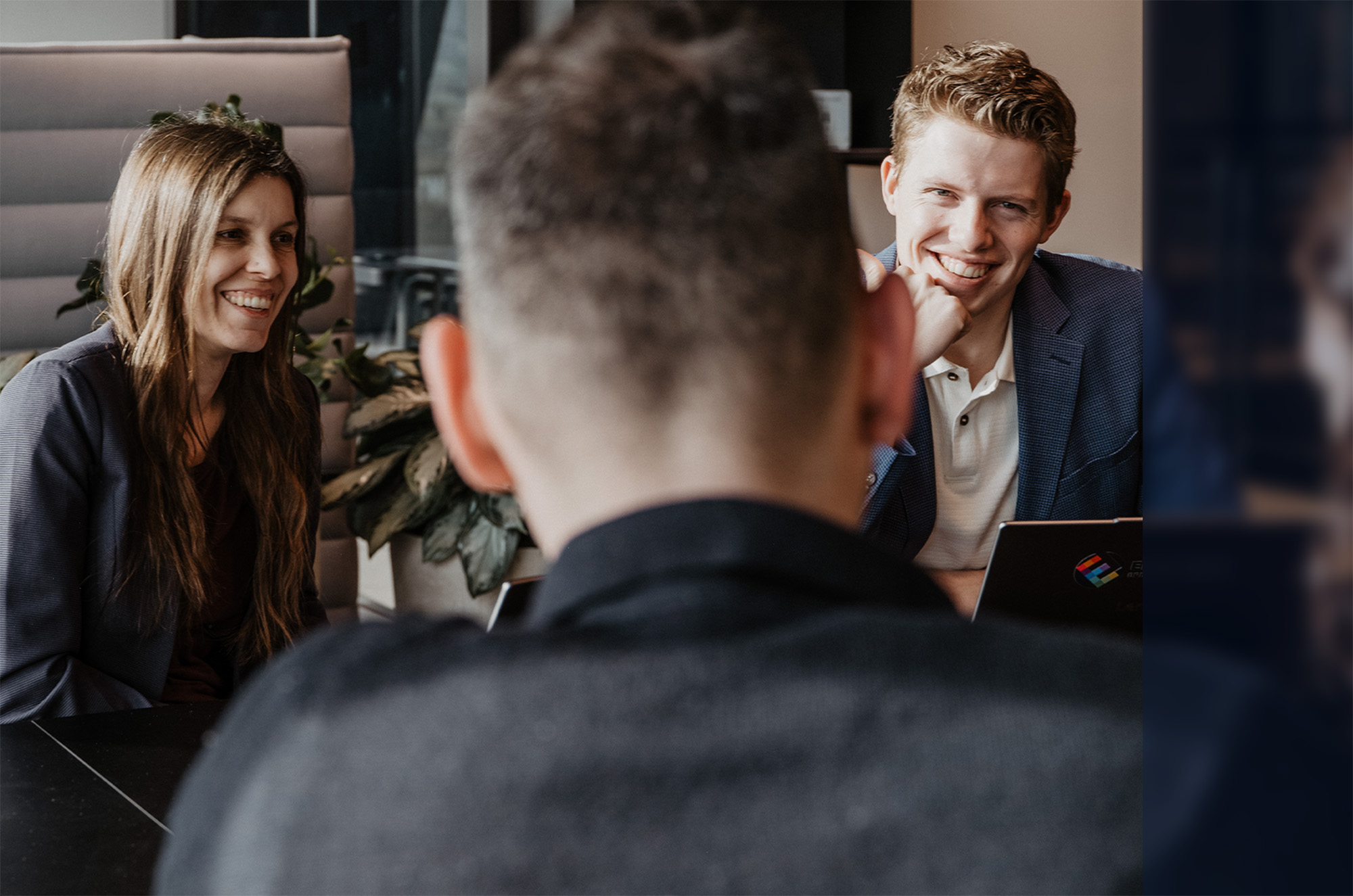 The Epic Fusion Team laughing at the conference table during a meeting with clients